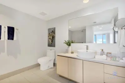 a white bathroom with a sink and a toilet at Amazing Pool - Gym - Complementary Shuttle in Hallandale Beach