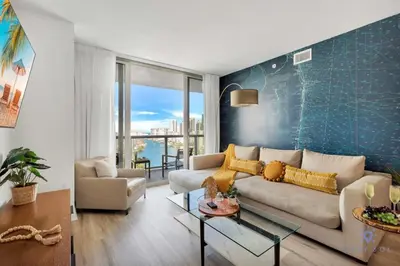 a living room with a couch and a table at Amazing Pool - Gym - Complementary Shuttle in Hallandale Beach