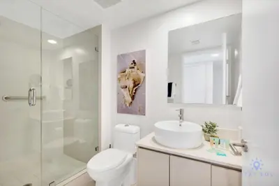 a bathroom with a toilet and a sink and a shower at Spectacular View with Balcony, Pool, Near Beach in Hallandale Beach
