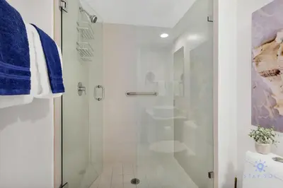 a white bathroom with a shower and a sink at Spectacular View with Balcony, Pool, Near Beach in Hallandale Beach