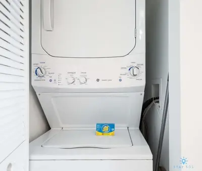 a white washer and dryer in a refrigerator at Infinite View with Balcony, Amazing Pool, Gym in Hallandale Beach