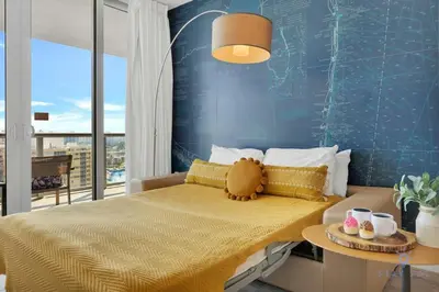 a bedroom with a bed with a teddy bear on it at Infinite View, Balcony with Gym and Amazing Pool in Hallandale Beach