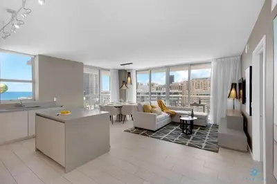 a kitchen and living room with a view of the ocean at Wrap Around Balcony, Insane Amenities, Amazing Pool in Hollywood
