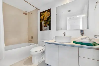a white bathroom with a sink and a toilet at Beachwalk Resort - PENTHOUSE IN THE SKY 3BDR and 3BA LUXURY CONDO DIRECT OCEAN VIEW in Hallandale Beach