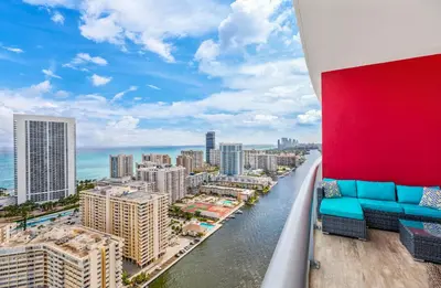 a balcony with a view of the ocean and buildings at Beachwalk Resort - PENTHOUSE IN THE SKY 3BDR and 3BA LUXURY CONDO DIRECT OCEAN VIEW in Hallandale Beach