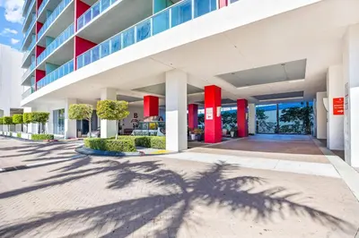 a shadow of a palm tree in front of a building at Beachwalk Resort - PENTHOUSE IN THE SKY 3BDR and 3BA LUXURY CONDO DIRECT OCEAN VIEW in Hallandale Beach