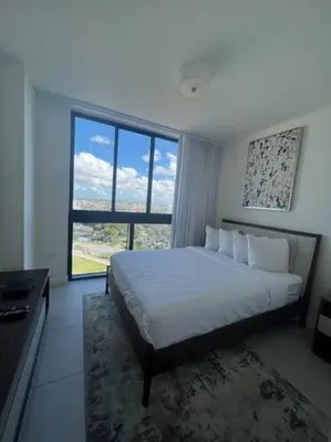 a bedroom with a large bed and a large window at APARTMENT FOR RENT 2 BED 2 BATH 1 Parking DOWNTOWN DORAL in Miami