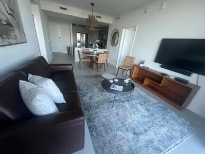 a living room with a couch and a tv and a table at APARTMENT FOR RENT 2 BED 2 BATH 1 Parking DOWNTOWN DORAL in Miami