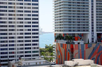 a view of the ocean between two tall buildings at Center Stage- Downtown Parking Pool Hot Tub in Miami