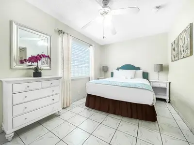 a bedroom with a bed and a dresser and a window at Hollywood by the Sea in Hollywood