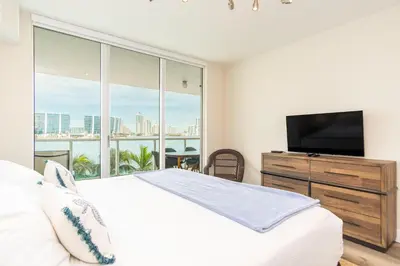a bedroom with a bed and a large window at Marina Bay 406 in Miami Beach