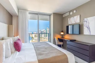 a bedroom with a bed and a desk and a window at Hyde Beach House 2601 in Hollywood