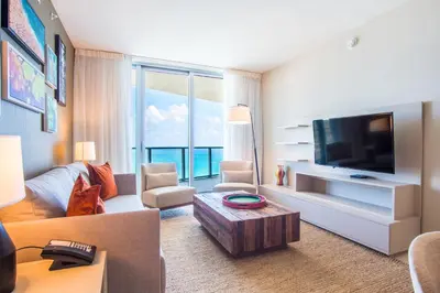 a living room with a couch and a tv at Lyfe Beach Resort 3804 in Hollywood Beach
