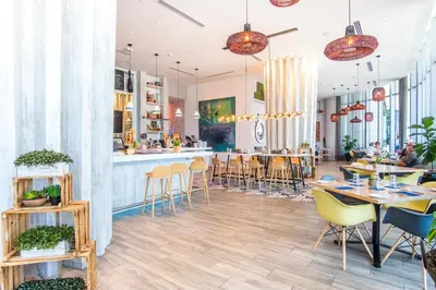 a restaurant with tables and chairs and a bar at Lyfe Beach Resort 3804 in Hollywood Beach