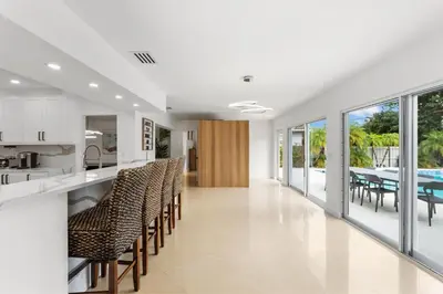 a kitchen and dining room with chairs and a table at Spacious Modern Mansion w Pool & Sauna in Hollywood close to Beach in Hollywood