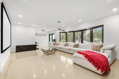 a living room with white furniture and a red blanket at Spacious Modern Mansion w Pool & Sauna in Hollywood close to Beach in Hollywood
