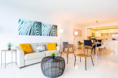 a living room with a couch and a table and chairs at Ocean Reserve 1006 in Miami Beach
