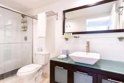 a bathroom with a toilet and a sink and a shower at Ocean Reserve 1006 in Miami Beach