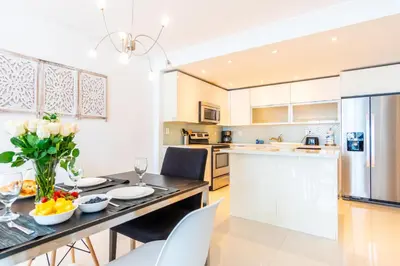 a kitchen and dining room with a table and chairs at Ocean Reserve 1006 in Miami Beach