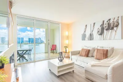 a living room with a white couch and a table at Marina Bay 1008 in Miami Beach