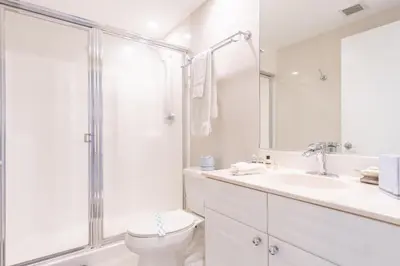 a white bathroom with a toilet and a shower at Golden Bay 703 in Miami Beach