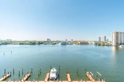 a boat is docked at a dock on a river at Golden Bay 808 in Miami Beach