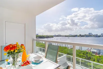 a dining room with a view of the water at Golden Bay 408 in Miami Beach