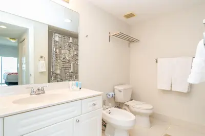 a white bathroom with a sink and a toilet at Golden Bay 408 in Miami Beach