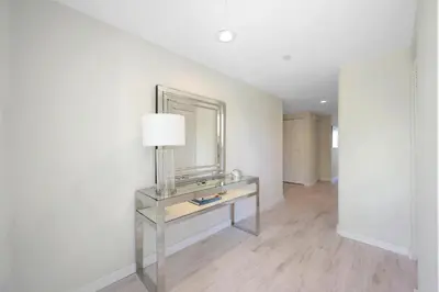a room with a table with a mirror and a lamp at Golden Bay 506 in Miami Beach