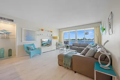 a living room with a couch and a large window at Golden Bay 506 in Miami Beach