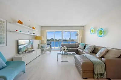 a living room with a couch and a tv at Golden Bay 506 in Miami Beach