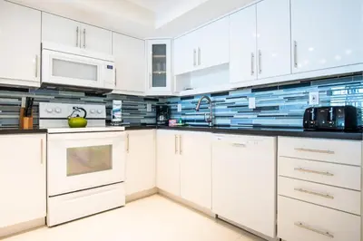 a white kitchen with white cabinets and appliances at Ocean Reserve 927 in Miami Beach
