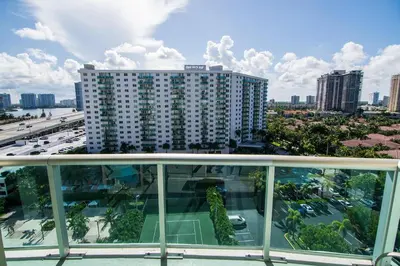 a balcony with a view of a building and a tennis court at Ocean Reserve 1112 in Miami Beach