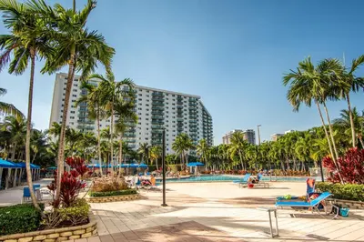 a resort with palm trees and a swimming pool at Ocean Reserve 1112 in Miami Beach