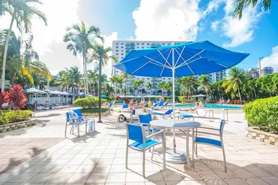 a table and chairs with an umbrella and a pool at Ocean Reserve 1112 in Miami Beach
