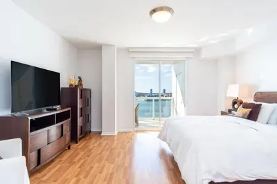 a bedroom with a large bed and a television at Golden Bay 805 in Miami Beach