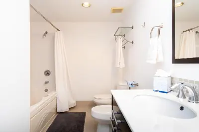 a white bathroom with a sink and a toilet at Golden Bay 805 in Miami Beach