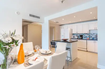 a kitchen and dining room with a table and chairs at Ocean Reserve 1404 in Miami Beach