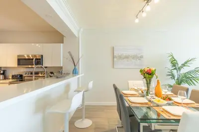 a dining room and kitchen with a table and chairs at Golden Bay 402 in Miami Beach