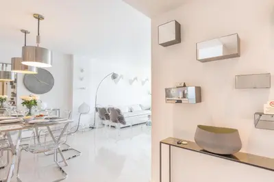 a white living room with a table and chairs at Ocean Reserve 1508 in Miami Beach