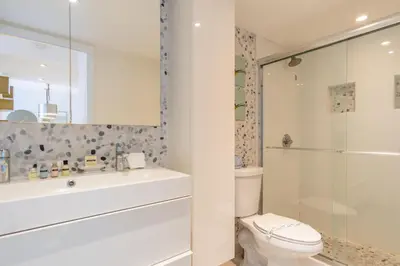 a bathroom with a toilet and a sink and a shower at Ocean Reserve 1508 in Miami Beach