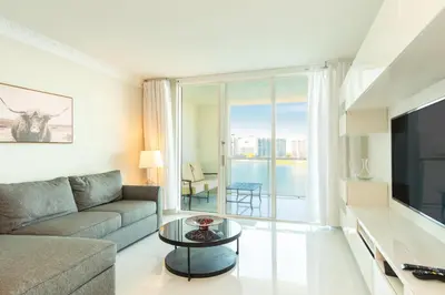 a living room with a couch and a large window at Marina Bay 1103 in Miami Beach