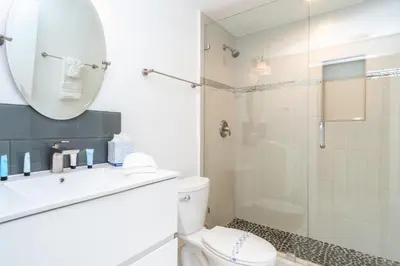a bathroom with a shower and a toilet and a mirror at Marina Bay 1103 in Miami Beach