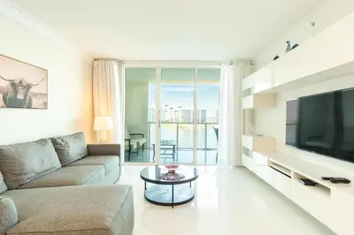 a living room with a couch and a tv at Marina Bay 1103 in Miami Beach