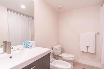 a white bathroom with a sink and a toilet at Golden Bay 508 in Miami Beach