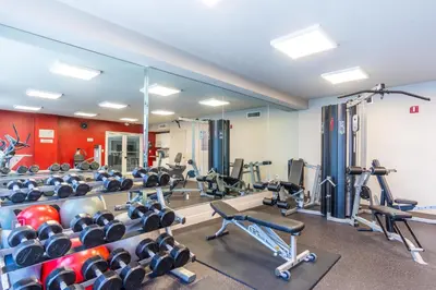 a gym with lots of treadmills and machines at Golden Bay 508 in Miami Beach