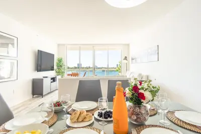 a dining room with a table with food on it at Golden Bay 606 in Miami Beach