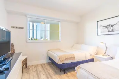 a bedroom with two beds and a window at Golden Bay 606 in Miami Beach