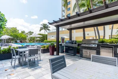 a patio with a grill and a table and chairs at Golden Bay 606 in Miami Beach