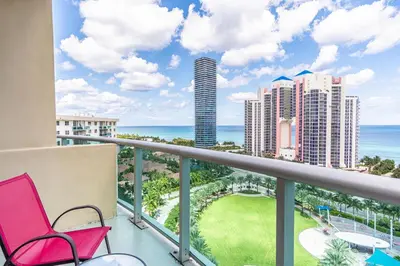 a balcony with chairs and a view of the ocean at Ocean Reserve PH1 in Miami Beach